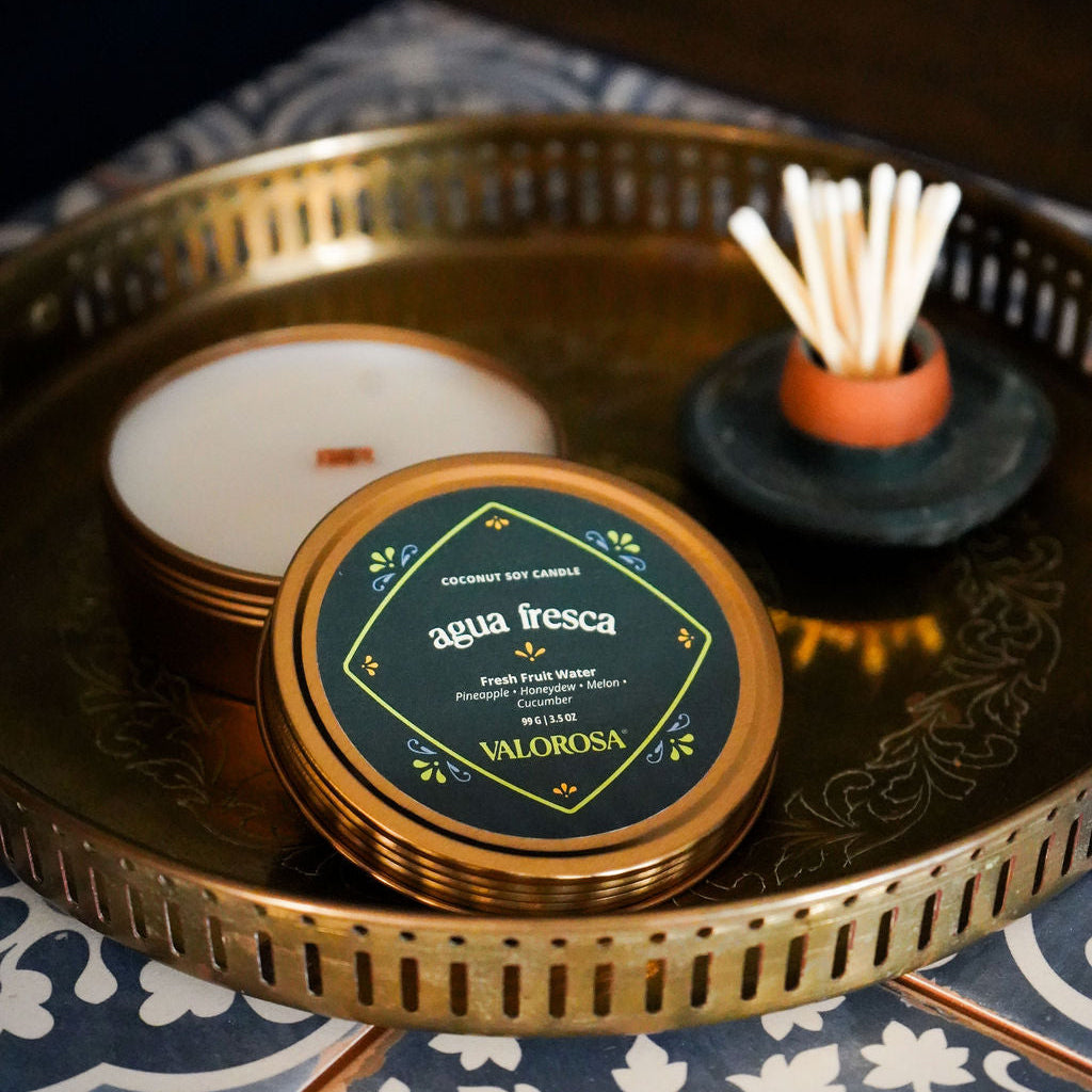 Agua Fresca Candle Tin with matches on a gold tray