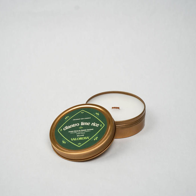 Candle in a tin with a green label on a white background