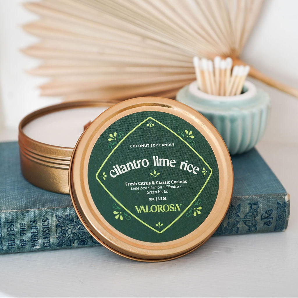 Coconut soy candle with 'Valorosa' branding on a white surface with decorative elements.