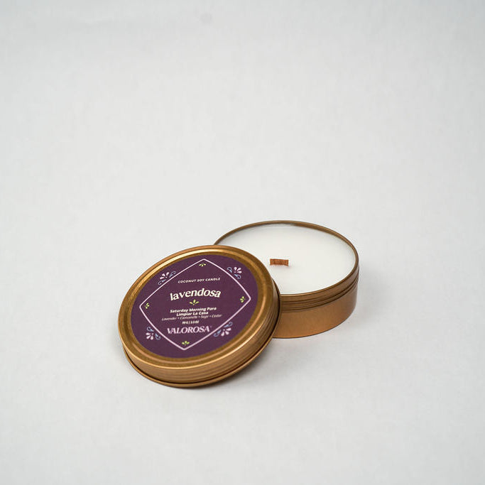 Candle in a tin with a purple label on a white background