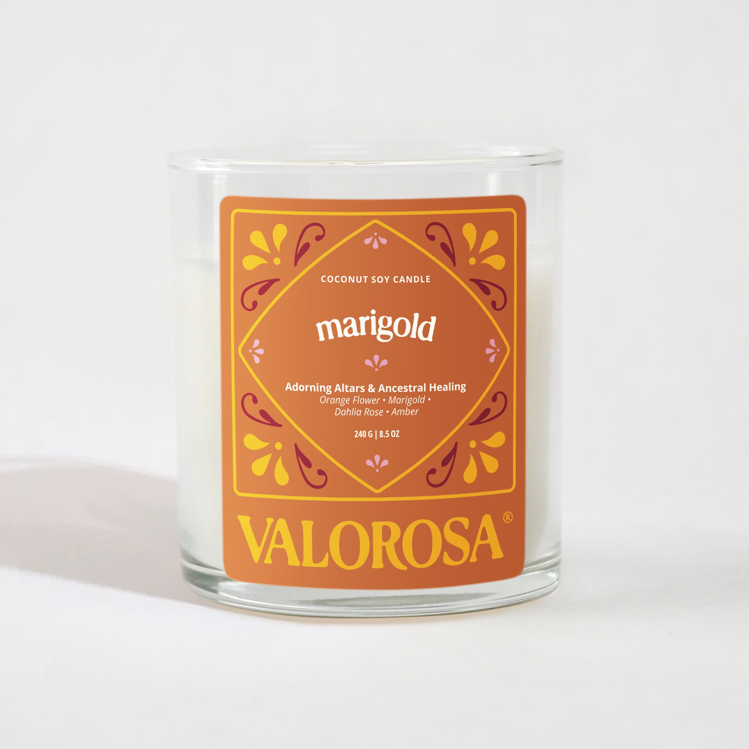 Glass candle with a marigold label on a white background