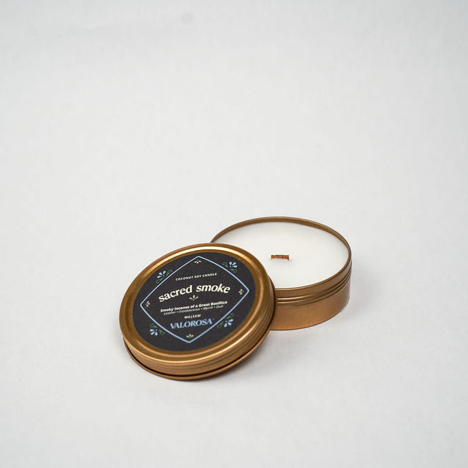 Candle in a bronze tin with a black label on a white background