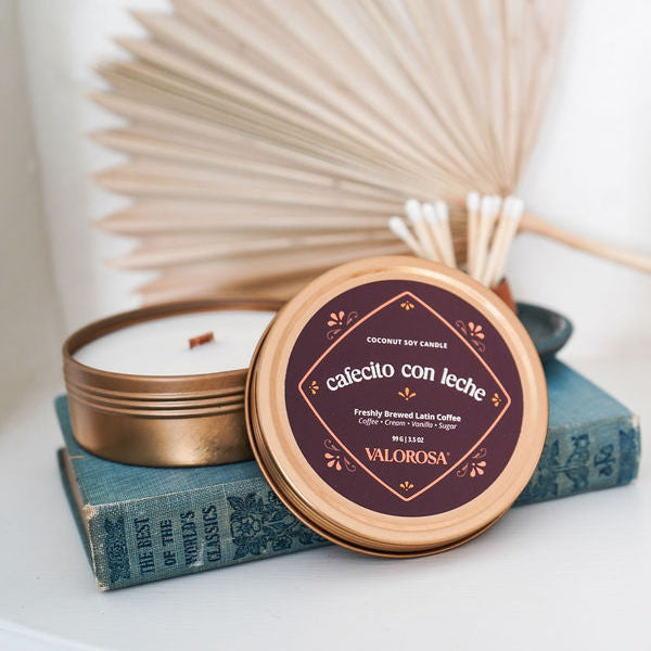 Cafecito Con Leche Candle with 'Valorosa' branding on a white surface with decorative elements.