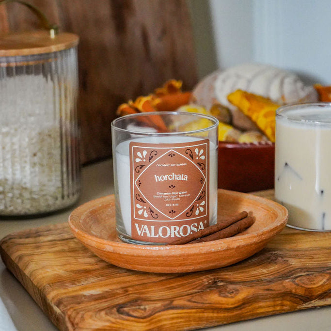 Horchata Candle on a wooden surface with a blurred background